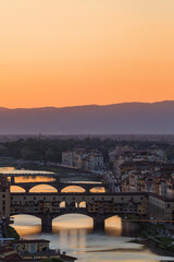 Fototapeta na wymiar Sunset at Florence skyline with Ponte vecchio arch bridge