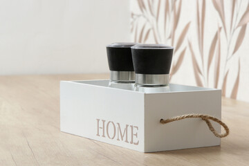 Salt and pepper containers in the wooden box on the kitchen counter	