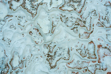Textured background of abstract shape limestone deposits of travertine Pamukkale. Top view.