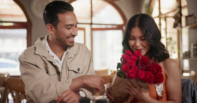 Happy, roses and couple on date in restaurant for valentines day, anniversary or romantic celebration. Love, conversation and young man and woman with bouquet of flowers at dinner or lunch at cafe.