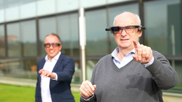 Businessman experiencing with augmented mixed vision headset in an urban park next to financial building