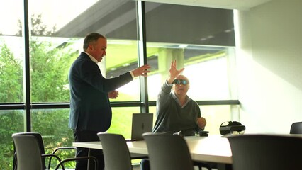 Businessman presenting a innovative mixed reality goggles to a client sitting in the office