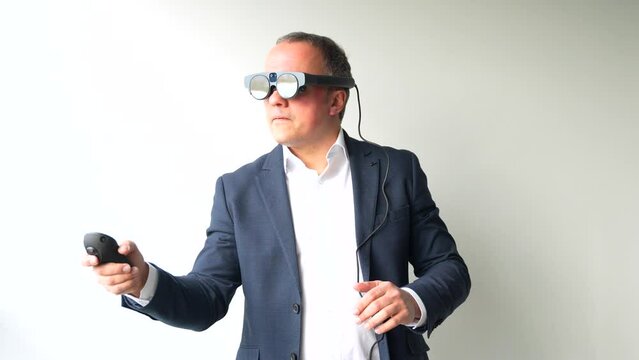 Smiling confident businessman with VR goggles touching interactive screen in office