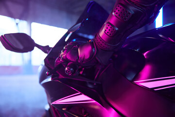 Motor biker driving sport motorcycle in neon light