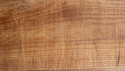 Texture of a scratched kitchen board; saw cut wood; brown color