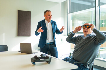 Businessman presenting a innovative mixed reality goggles to a client