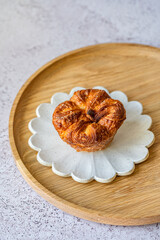 Kouign-amann is a sweet Breton cake made with laminated dough. It is a round multi-layered cake, originally made with bread dough, containing layers of butter and incorporated sugar
