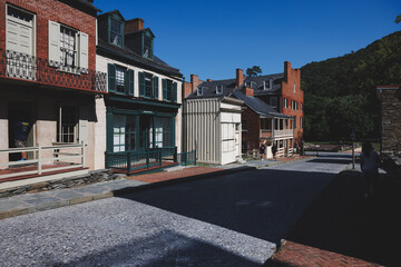 Fototapeta premium City buildings and sidewalk near mountains: Harper's Ferry, West Virginia