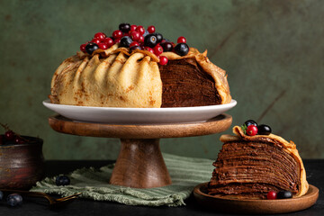 Homemade layered crepe cake, made of type of thin pancake and chocolate cream, decorated with...