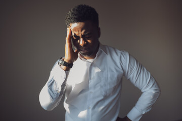 Portrait of young businessman who is tired and having headache.