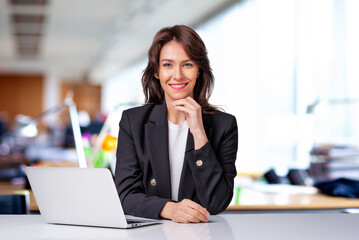 Executive businesswoman sitting at the office and using her laptop for work