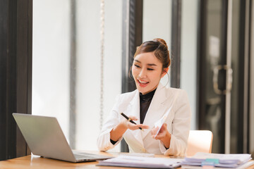 Businesswoman using computer to do daily tasks at modern office.