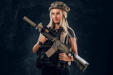 Fototapeta na wymiar Beautiful Fragile Blond Girl With Machine Gun Full Army Uniform Helmet