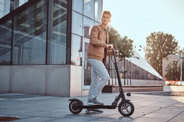 Young Attractive Student Is Driving His Scooter Neat Interesting Glass Building Bright Sunny Day - Powered by Adobe