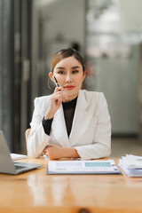 Asian woman working through laptop. business woman busy working with laptop computer at office