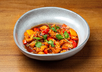 Chinese chicken in sweet and sour sauce in a plate.