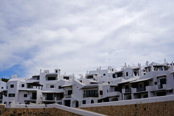 Fototapeta na wymiar Exterior Spanish architecture and building design of The quaint old fishing village of Binibeca Vell (Binibèquer Vell), white houses form a small labyrinth of narrow, cobbled corridors- Menorca, Spain