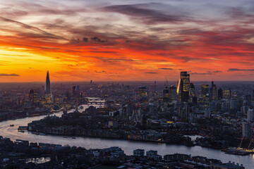 Panoramic view of the urban skyline of London City along the River Thames during a colorful sunset, England