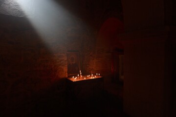 Burning candles fire in church with light