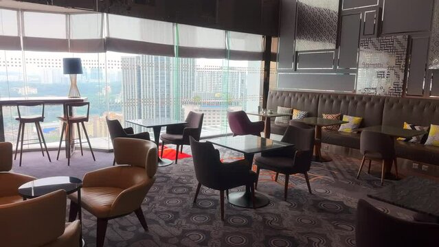 Club lounge with chairs and tables and a nice view. Executive club lounge. Empty restaurant. 
