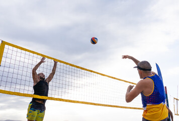 Two men playing beach volleyball