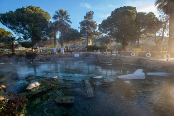 The Antique pool (Cleopatra's Bath) view in Pamukkale. It's a popular touristic destination during...