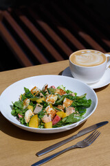 salad with haloumi cheese and a cup of coffee mix salad, asparagus, chicken, potatoes, cherry