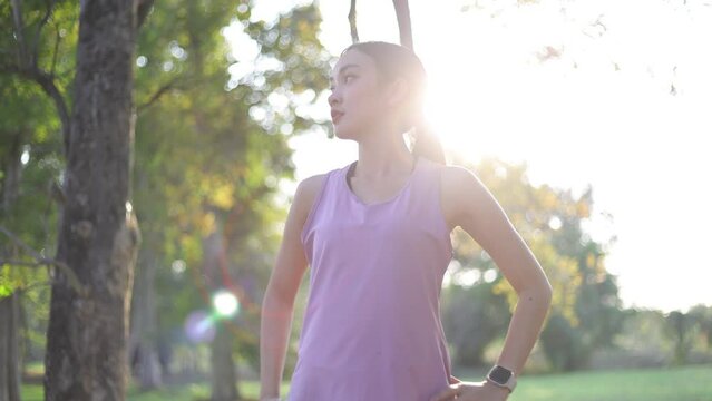 Young healthy woman exercising outdoors by running, She is warming up her body.