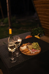 a picnic with wine in the evening on the terrace. romantic dinner with candles and wine