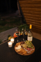 a picnic with wine in the evening on the terrace. romantic dinner with candles and wine