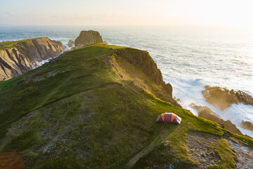 Camping tent on the cliff at Scheildren, most iconic and photographed landscape at Malin Head, Wild...