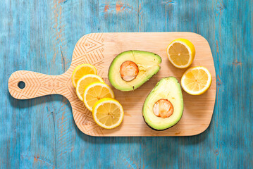 Lemon and avocado, fresh fruit on wooden board, healthy food concept, TOP VIEW - 739857900