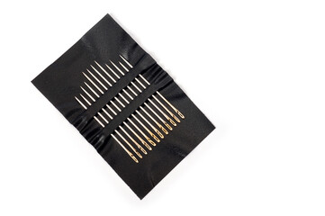 Metal sewing needles for hand sewing on an artificial leather base.
