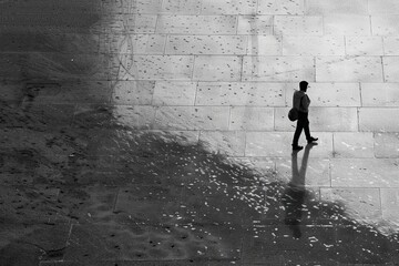 Black and white photo, one man standing on the ground - obrazy, fototapety, plakaty