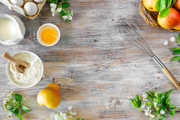 Ingredients for baking fresh pears on a wooden background. Top view. Copy Space