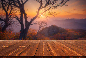 Beautiful autumn sunset scene with empty wooden table. Natural template landscape