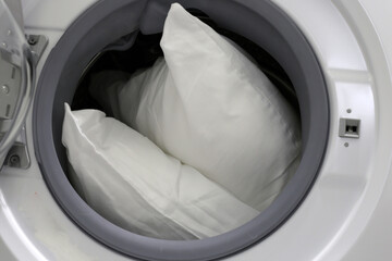White pillow in washing machine.