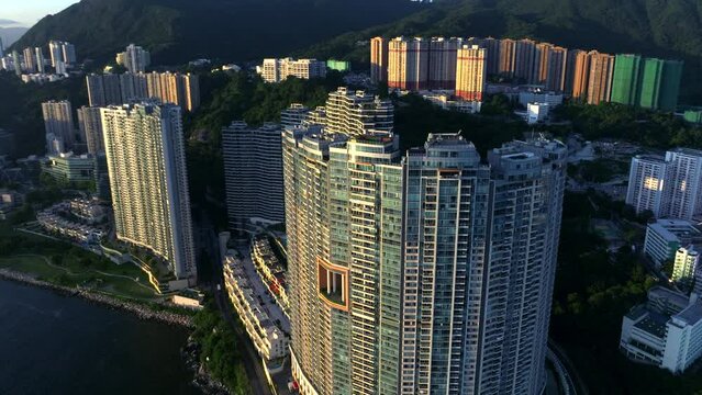 High-rise residential building (Bel Air) in Cyberport, Hong Kong during sunset time. Aerial orbit top down.