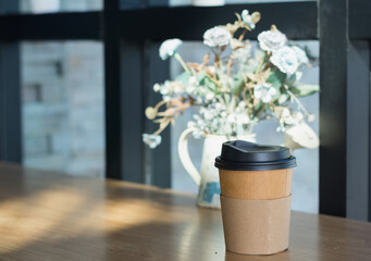 Brown  papaer coffee cup on desk in cafe,selective focus.