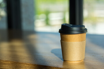 Brown  papaer coffee cup on desk in cafe,selective focus.