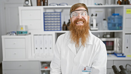 Smiling young redhead scientist, full of confidence, man in lab sporting secure glasses