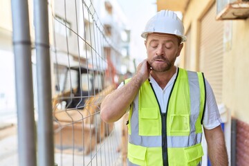 Middle age man architect standing with relaxed expression at street