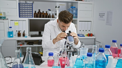 Passionate young hispanic man engrossed in serious scientific research, fully concentrated,...
