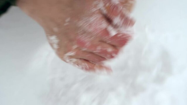 Man rubbing snow on hands to boost circulation and immune system during winter