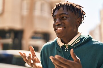 African american man smiling confident speaking at street