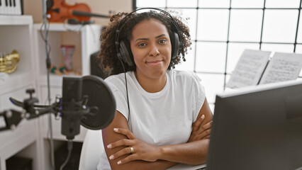 Black woman with headphones in a music studio