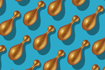 A large group of cosmetic capsules of renovative facial serum on blue background. Top view.