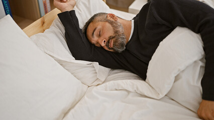 Mature hispanic man with grey beard sleeping peacefully in a bedroom setting - Powered by Adobe