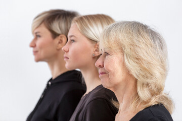 Portrait of three generations of blonde women in a family. Serious mother, grandmother and...