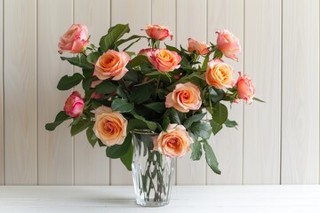 Fresh bouquet of rose flowers in vase on wooden background